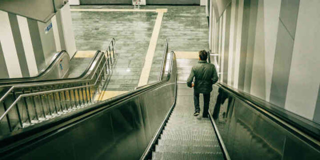 Wlaking away down escalator